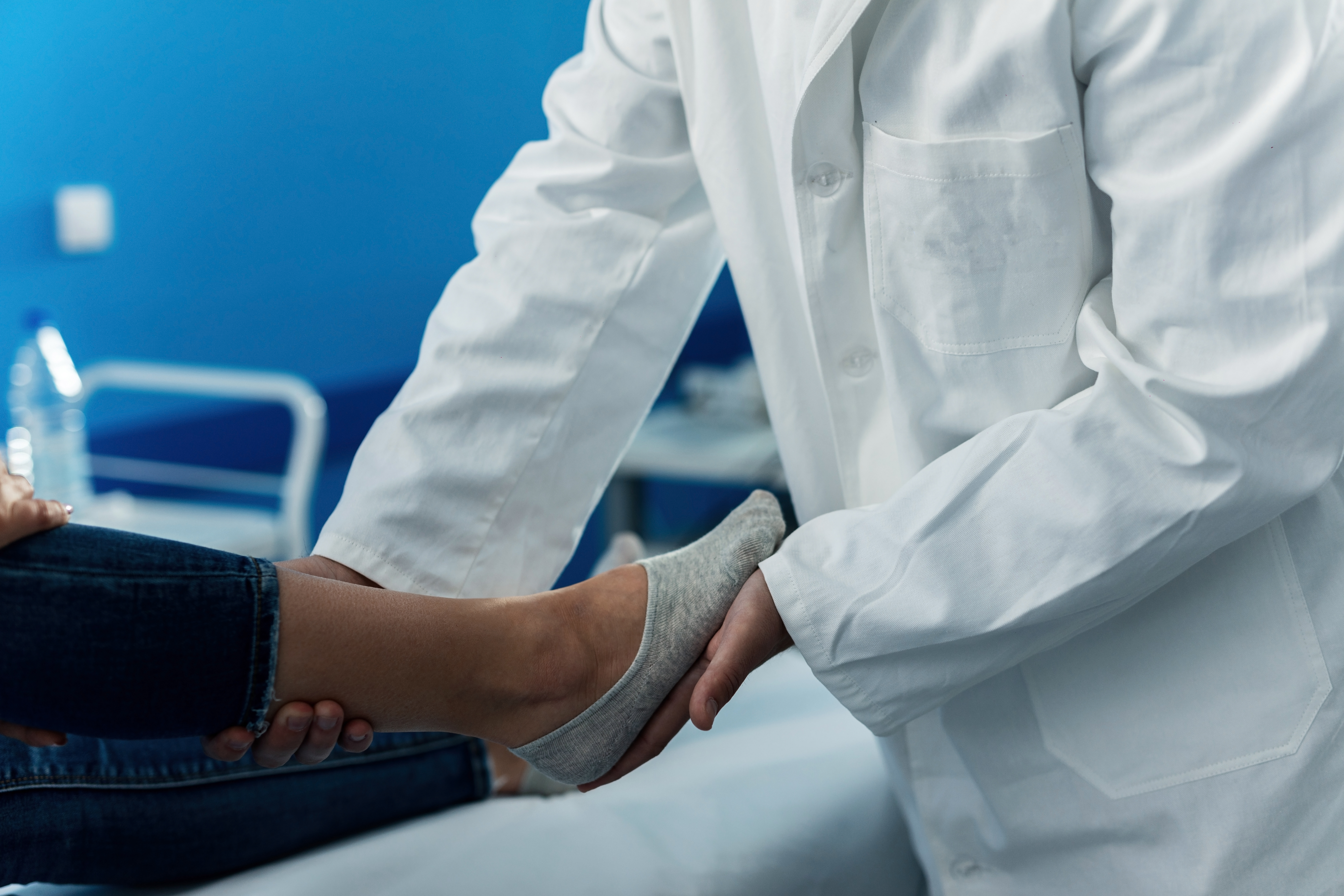 doctor examining woman's foot