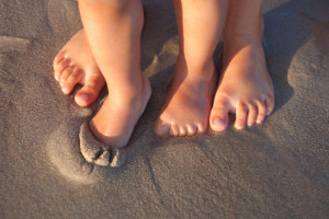 children's feet in the sand