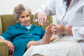 trimming elderly person's toenails