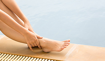 person rubbing foot and ankle